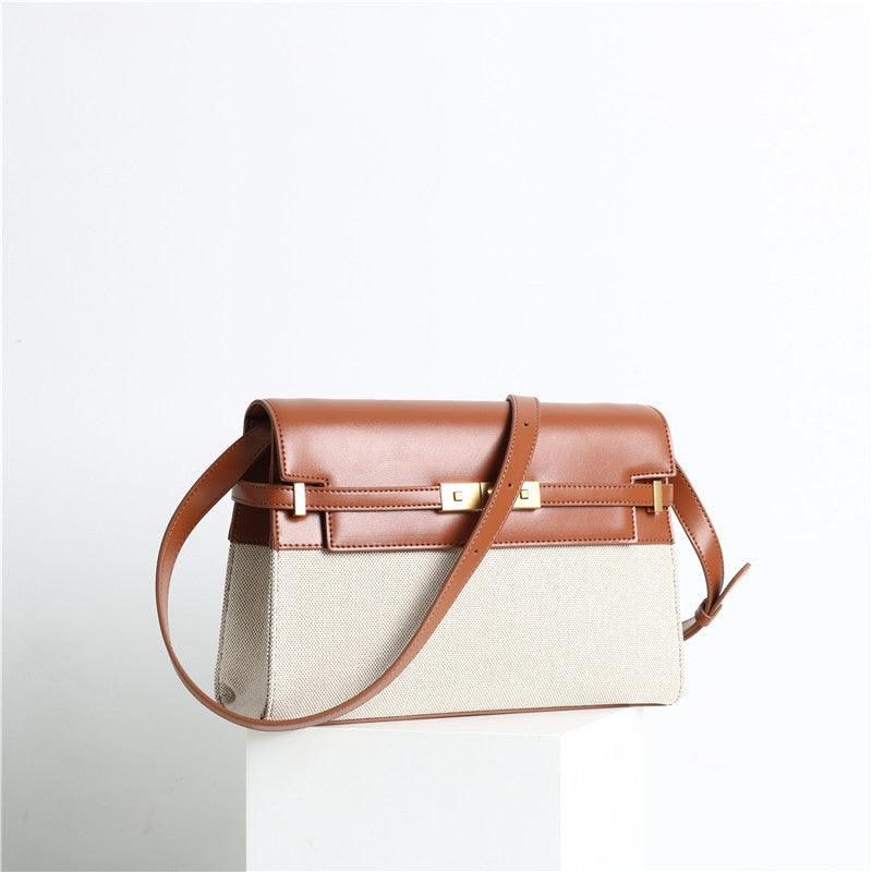 Minimalist leather and canvas crossbody bag with brown flap, gold clasp, and shoulder strap