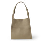 Beige grain cowhide leather tote bag with shoulder straps, minimalist design, front pocket.