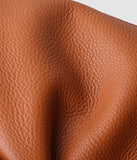 Close-up of brown grain cowhide leather texture for tote bag or shoulder bag
