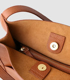 Brown grain cowhide leather tote bag with suede interior, zipper pocket, and magnetic closure