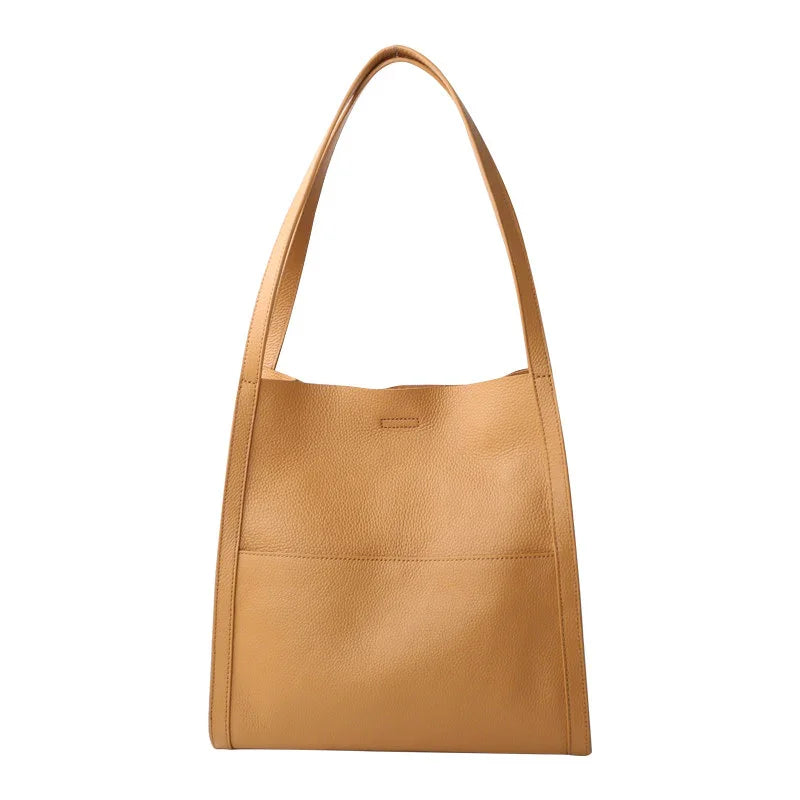 Tan grain cowhide leather tote bag with minimalist design and shoulder straps