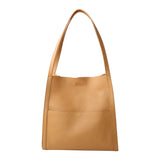 Tan grain cowhide leather tote bag with minimalist design and shoulder straps