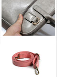 Detail of grey leather laptop bag with D-ring and detachable pink shoulder strap