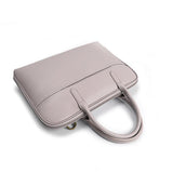 Slim light beige leather laptop bag for women with handles, fits 14 inch, on white background