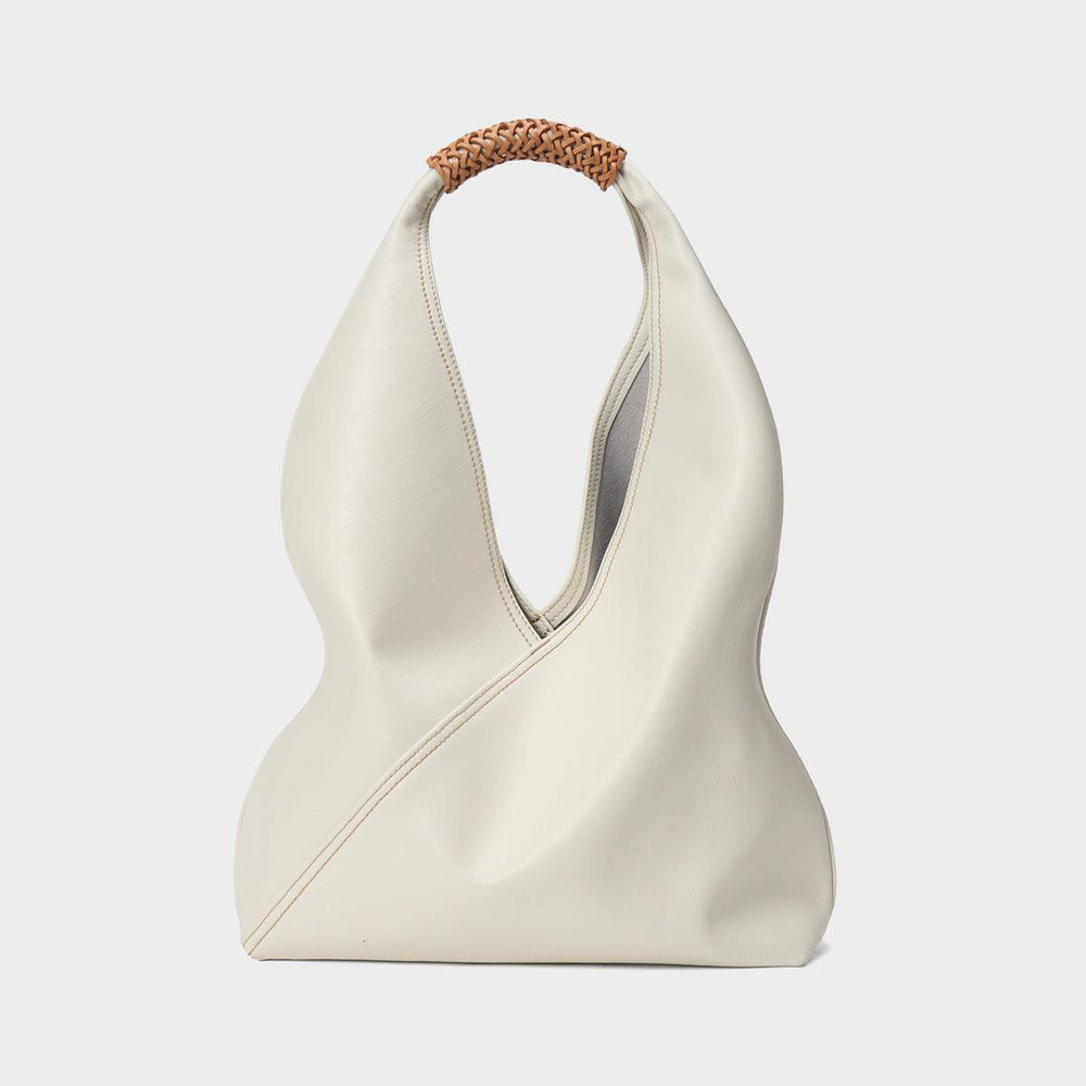 Minimalist white genuine leather bucket bag with brown woven handle, modern fashion tote