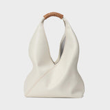 Minimalist white genuine leather bucket bag with brown woven handle, modern fashion tote