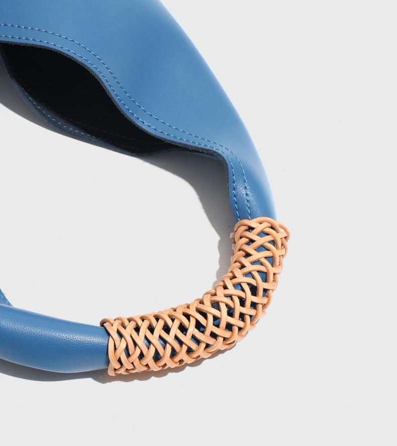 Blue genuine leather tote bag with tan woven handle, minimalist design, fashion accessory