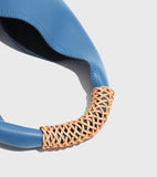 Blue genuine leather tote bag with tan woven handle, minimalist design, fashion accessory