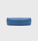 Bottom view of blue genuine leather minimalist bucket bag on white background