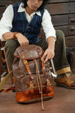 Men’s brown cowhide leather military style backpack with brass buckles and drawstring