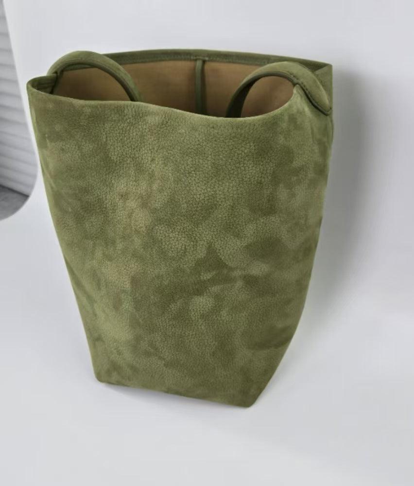 Large olive green suede leather bucket bag with handles on a white background