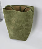 Large olive green suede leather bucket bag with handles on a white background