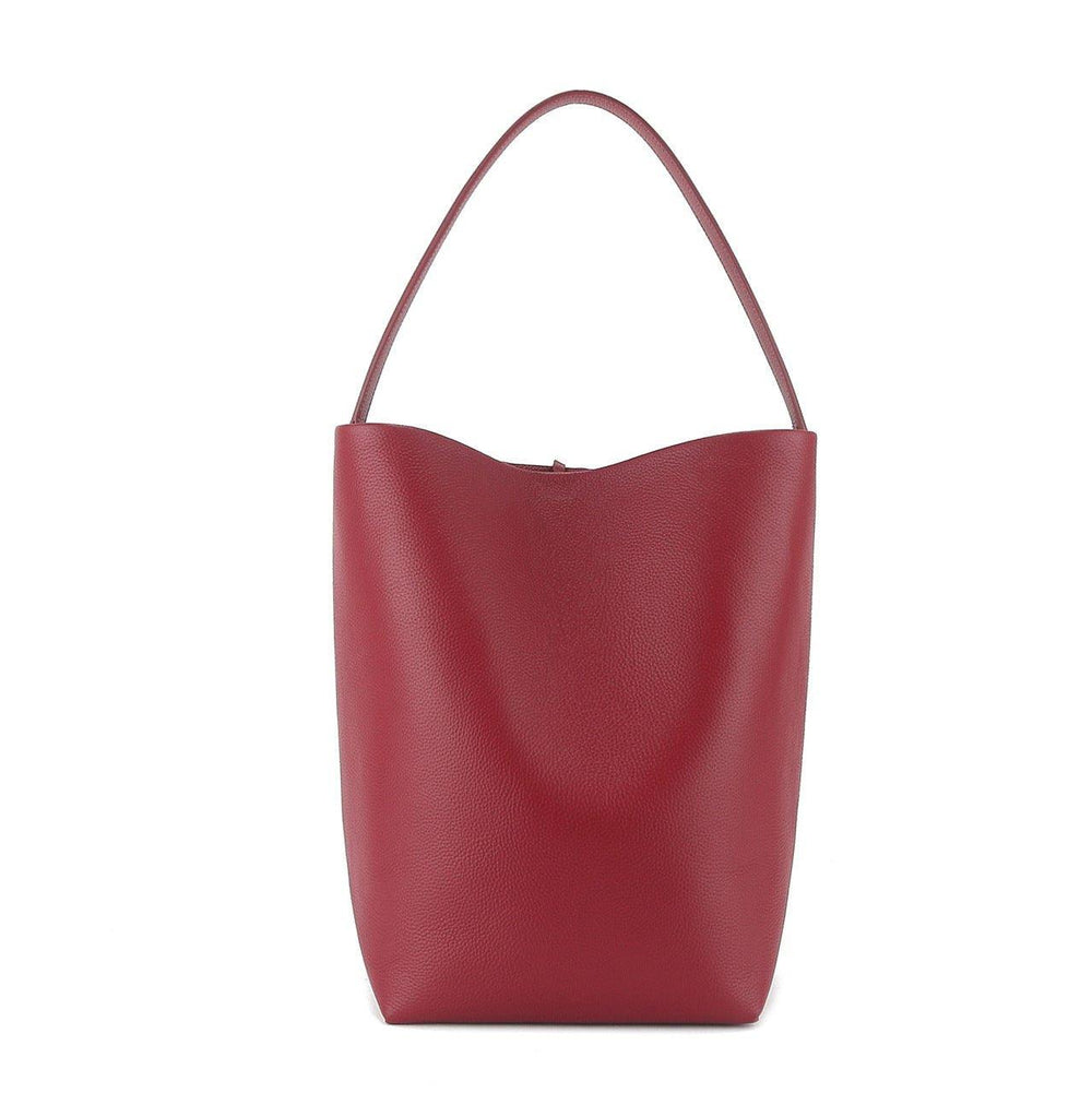 Minimalist large red leather bucket bag with single shoulder strap, tote style on white background