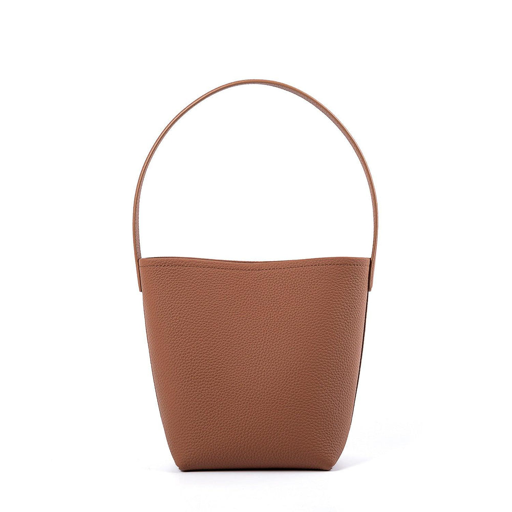 Minimalist tan leather bucket bag with shoulder strap, large tote style on white background