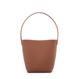 Minimalist tan leather bucket bag with shoulder strap, large tote style on white background