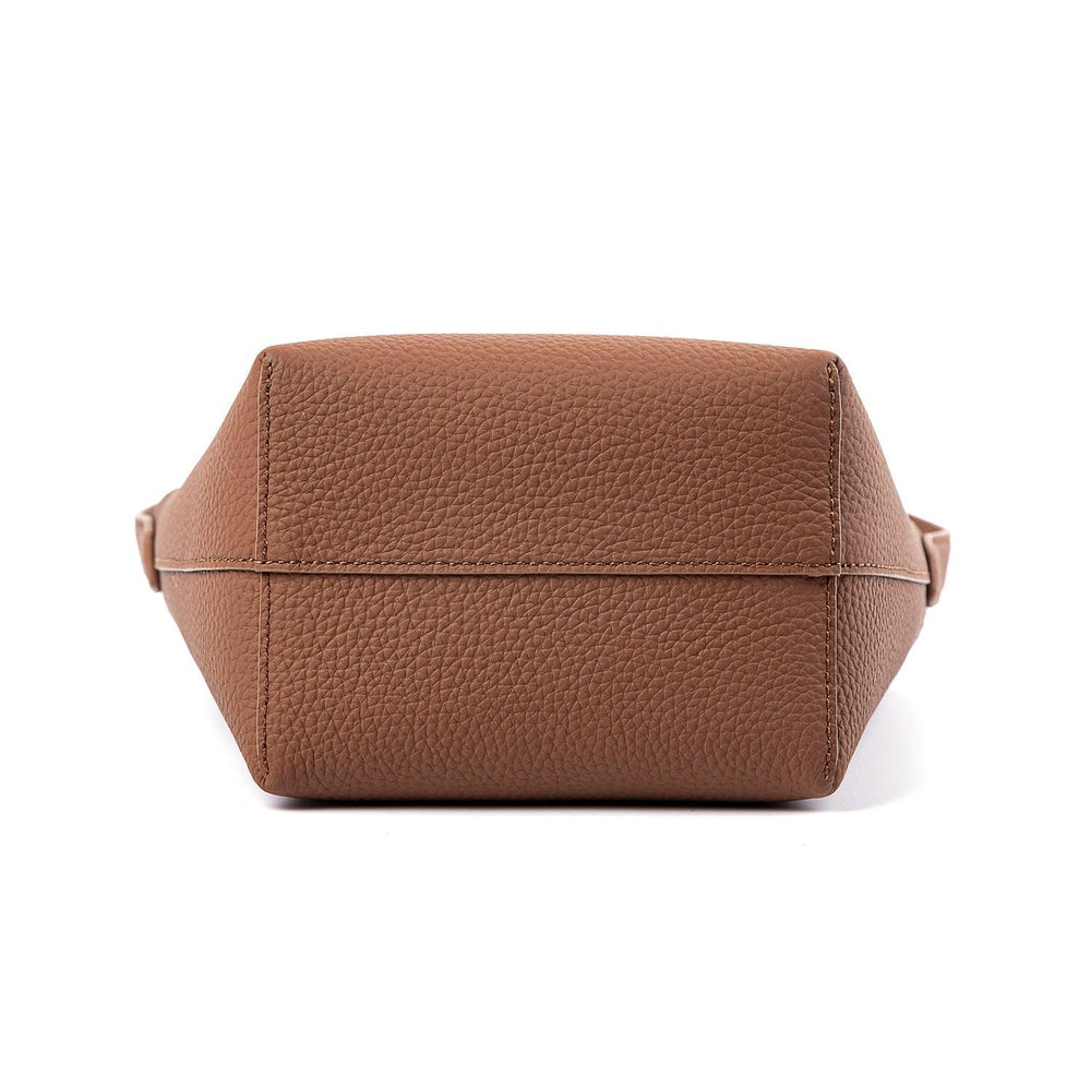 Bottom view of a tan minimalist leather bucket bag with textured finish