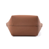 Bottom view of a tan minimalist leather bucket bag with textured finish