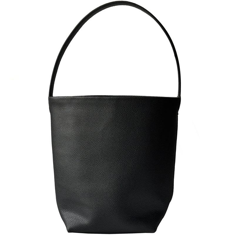 Minimalist black leather bucket bag with single shoulder strap on white background