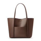 Minimalist brown genuine leather tote bag with top handles and front pocket on white background