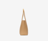 Side view of a minimalist beige genuine leather tote bag with double top handles