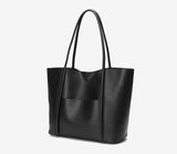 Minimalist black genuine leather tote handbag with top handles and front pocket on white background