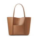 Minimalist beige genuine leather tote bag with pocket and top handles on white background