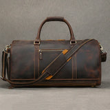Dark brown leather duffle bag with shoulder strap, front zipper pocket and sturdy handles.