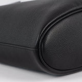 Close-up of black pebbled leather handbag bottom with soft, rounded edges and smooth stitching