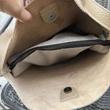 Interior of beige cowhide leather tote bag with suede lining and zippered pocket