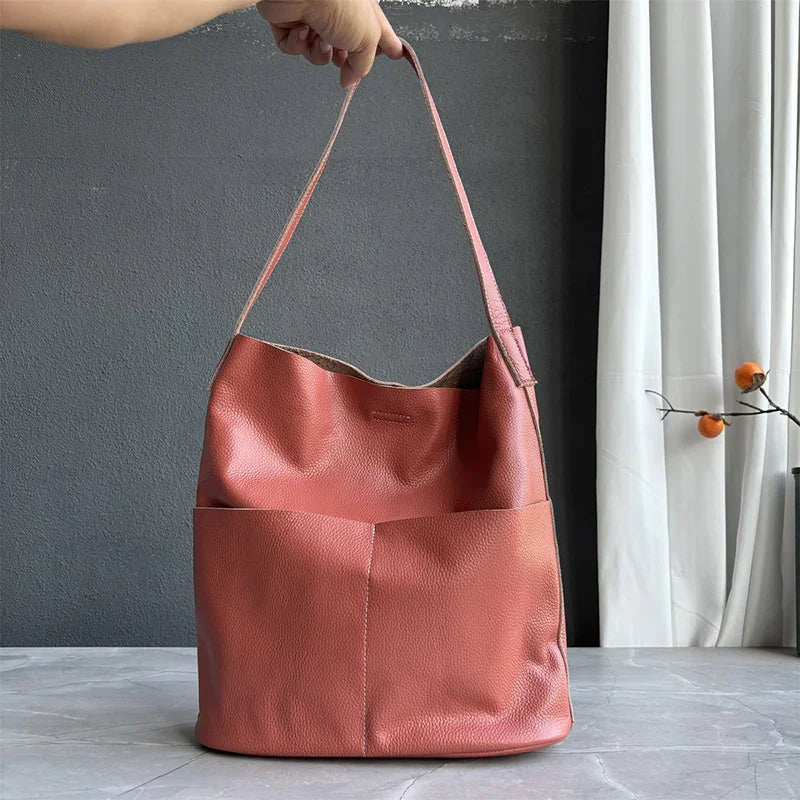 Soft cowhide leather tote bag in oak color with two front pockets, minimalist bucket design