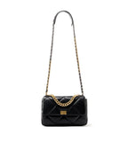 Black quilted leather shoulder bag with gold chain strap and diamond stitching on white background