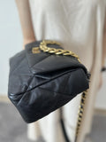 Black quilted leather shoulder bag with gold chain strap and flap closure