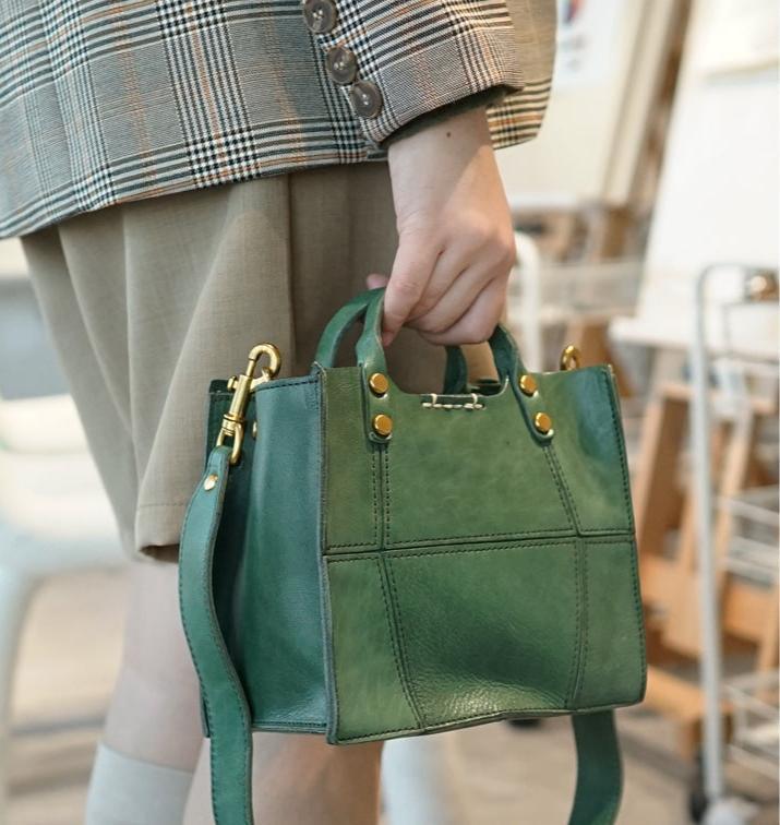 Small green full grain leather handbag with gold hardware and crossbody strap