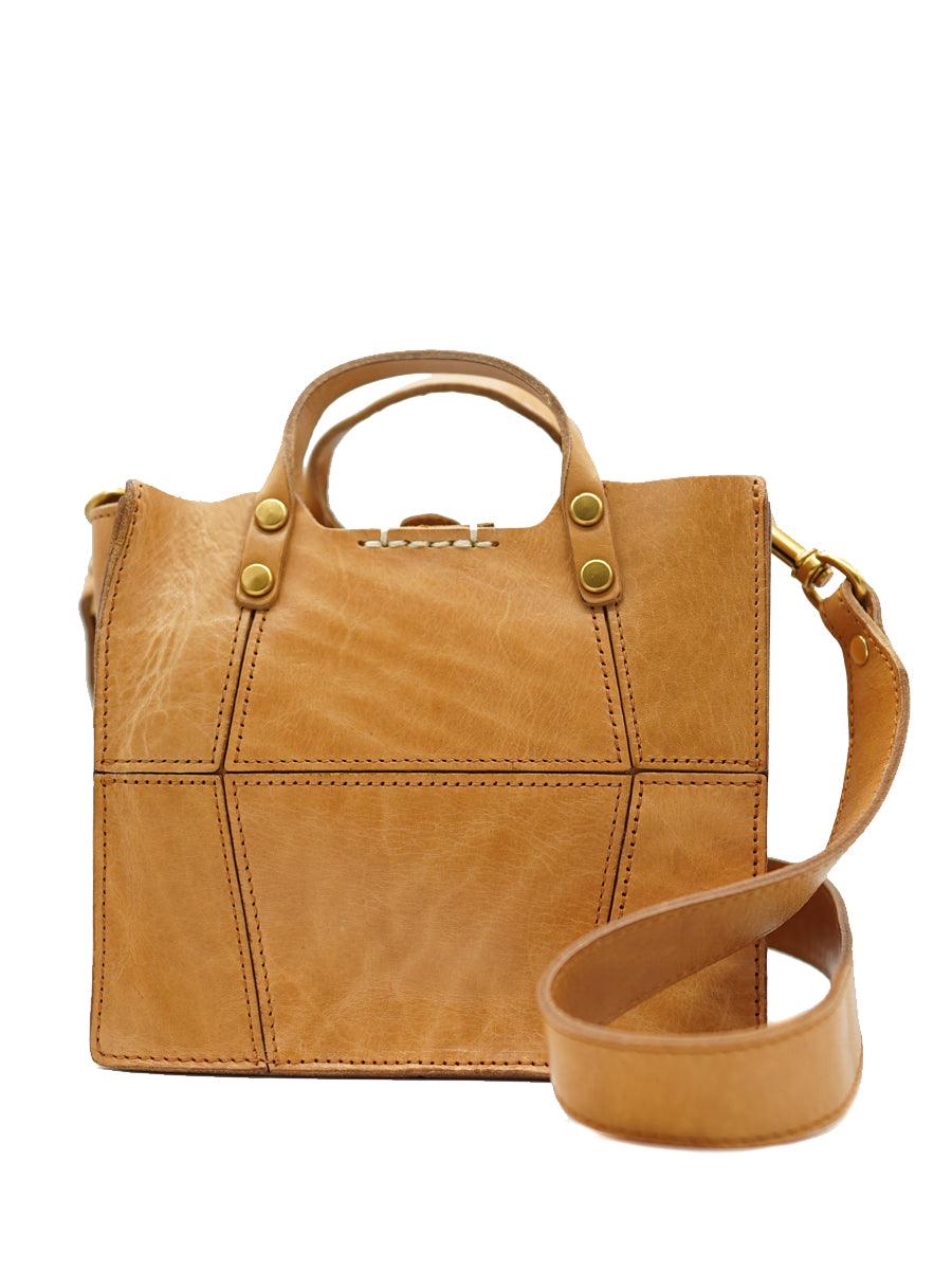 Tan full grain leather small handbag with top handle and adjustable crossbody strap