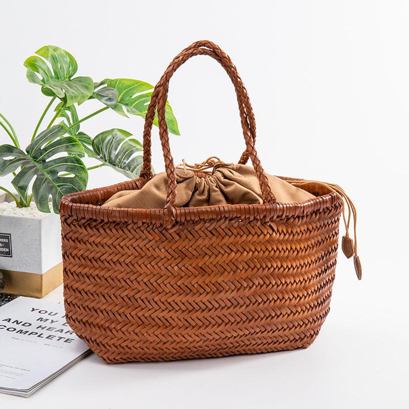 Handmade woven Italian leather tote bag with braided handles, drawstring closure, and natural finish.