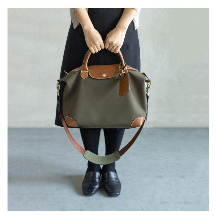 Woman holding olive waterproof nylon and cowhide tote bag with leather handles and strap