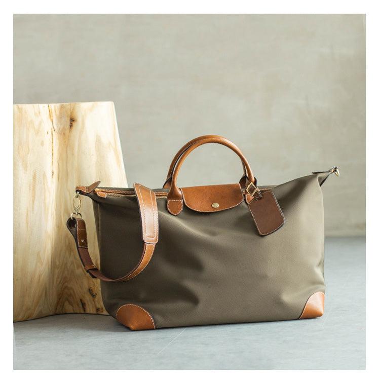 Handcrafted olive green waterproof nylon tote bag with brown cowhide leather accents and handles