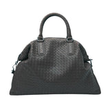 Large woven leather duffle bag with double handles in dark brown, on white background.