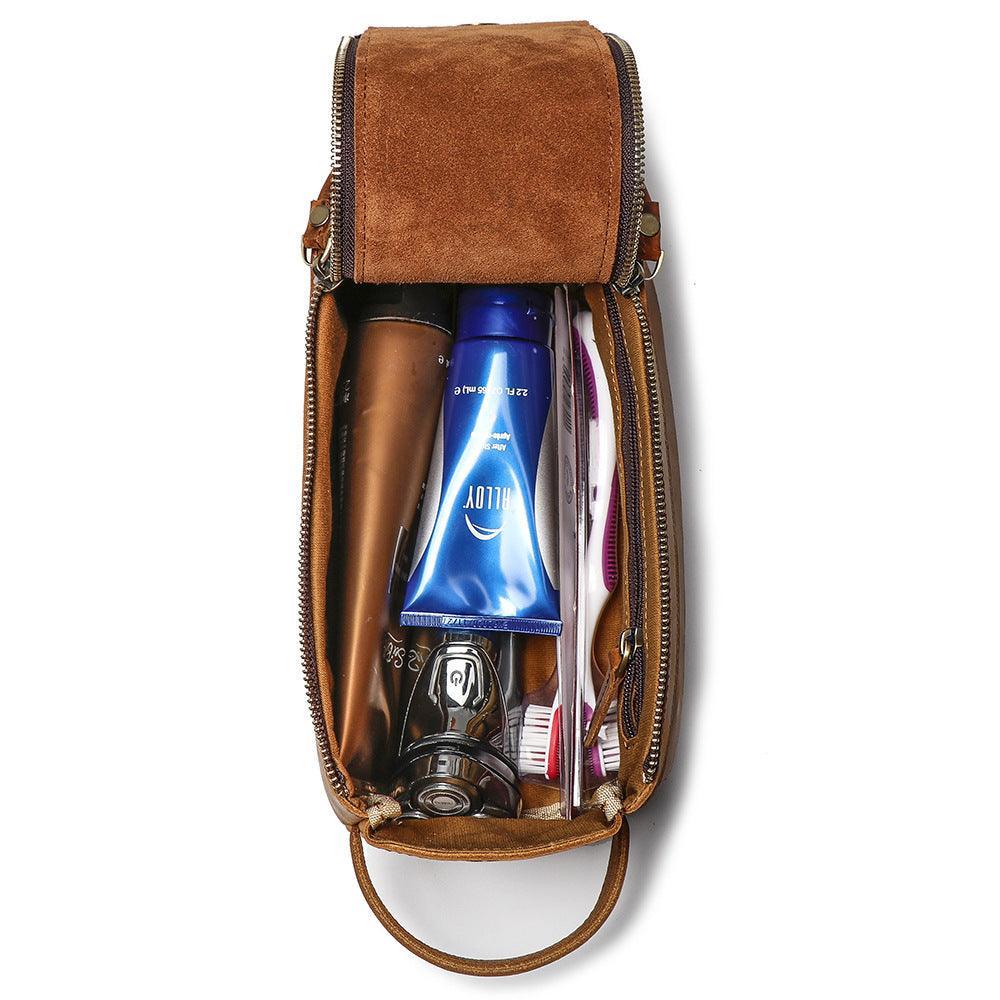 Open brown genuine leather toiletry bag with assorted cosmetics and grooming items inside