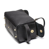 Black genuine leather handbag with gold hardware, top handle, and studded bottom