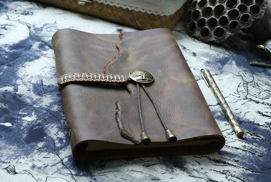A6 vintage leather sketchbook with button clasp, rustic design, on artistic map background