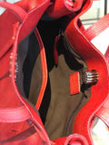 Interior of red leather women’s shoulder bag with zipper pocket and spacious compartment