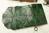 Green leather sketchbook with embossed leaf pattern, handmade journal with rustic charm
