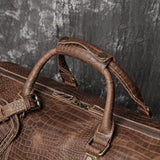 Brown full grain leather duffle bag with textured cowhide pattern and sturdy handles
