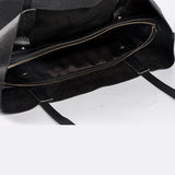 Black full grain leather tote bag with spacious interior and zippered pocket