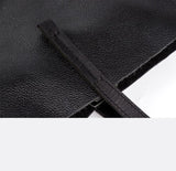 Close-up of black full grain leather tote bag with textured finish and sturdy handle