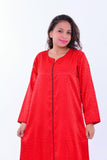 Woman in red silk boho kaftan dress with black trim and wide sleeves, resort wear style