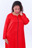 Woman wearing a red silk boho summer kaftan with long sleeves and black trim detail