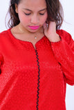 Woman wearing red boho silk kaftan dress with wide sleeves and subtle pattern details