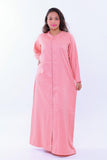 Woman wearing a pink handcrafted kaftan maxi dress with long sleeves on white background
